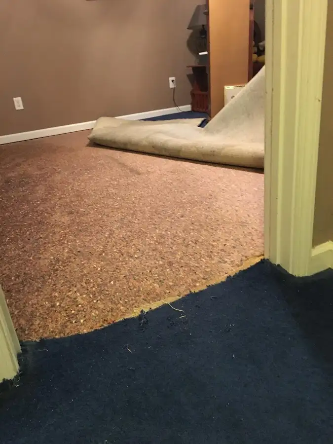 Carpet pad removal revealing water damage during Water Mitigation Services in Spearfish